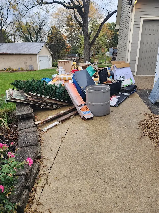 Dumpster being loaded with debris for 3 Yard Dumpster Rental in Dolton